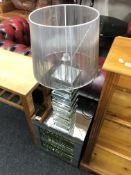 A contemporary mirrored side table fitted shelves,