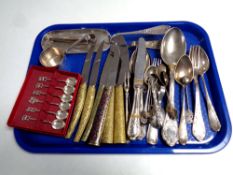 A tray containing assorted plated cutlery, cased teaspoons,