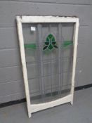 An antique stained glass leaded sash window in frame