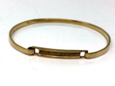 A 9ct gold diamond set bangle
