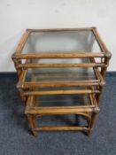 A nest of three bamboo and wicker glass topped tables