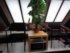 A pair of office armchairs upholstered in a black fabric together with a square IKEA occasional