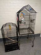 A parrot cage on stand together with a further bird cage