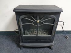 An electric heater in the form of a stove
