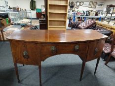A 19th century bow front inlaid mahogany sideboard with lion mask handles