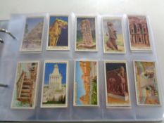 An album containing a quantity of Wills, John Player Special cigarette cards relating to Dickens,