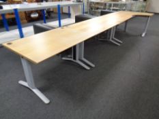 Three contemporary office desks on metal legs,