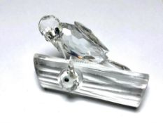 A Swarovski crystal woodpecker on branch