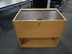 A portable wooden filing cabinet with shutter door top,