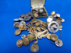 A quantity of mixed military cap badges and buttons,