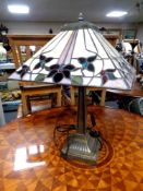 A contemporary table lamp with a leaded glass shade