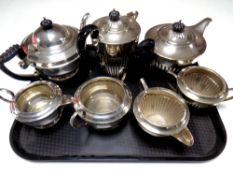 A tray containing a four piece plated tea service together with a three piece plated tea service