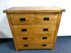 A contemporary oak five drawer chest