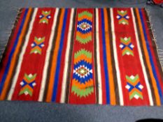 A fringed kilim rug,