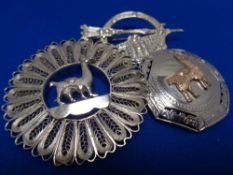 Three silver brooches
