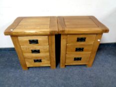 A pair of contemporary oak three drawer bedside chests