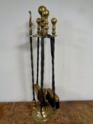 A four piece 19th century cast iron and brass companion set on stand