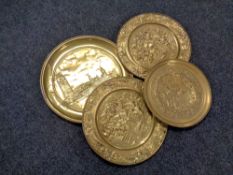 Four circular brass plaques