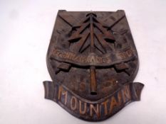 A Reconnaissance Corps carved plaque together with a pair of winter warfare skis by Mesta