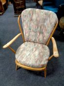 An Ercol solid elm and beech armchair