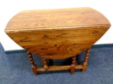 An Edwardian oak barley twist gate leg table