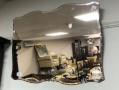 An Art Deco frameless amber tinted mirror