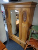 An Edwardian satin wood mirror door wardrobe, fitted a drawer beneath,