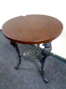 A circular bar table on a cast iron Britannia base,