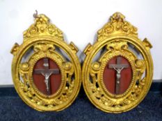 A pair of painted cast iron plaques with crucifixes