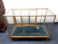 An early 20th century oak framed shop display cabinet,