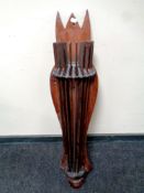 A wall sconce mounted on a pine board