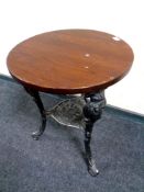 A circular bar table on a cast iron Britannia base ,