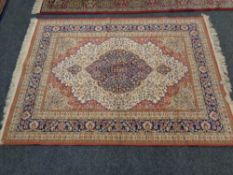 A machine made rug of Persian design,
