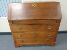 A 19th century oak fall front bureau fitted three drawers beneath,