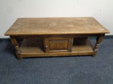 A Priory oak coffee table fitted a cupboard
