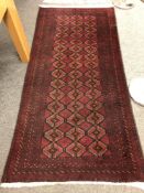 An Afghan runner 218cm by 110cm