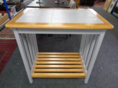 A contemporary pine tile topped kitchen table