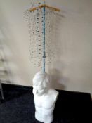 A wire mannequin on stand together with a shop mannequin torso of a man