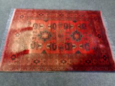 An Afghan rug (faded),