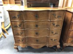 A 19th century oak serpentine fronted four drawer chest on cabriole legs,