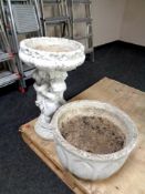 A concrete cherub bird bath together with a concrete planter