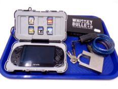 A tray containing PS Vita with five games in hard shell case, with lead,