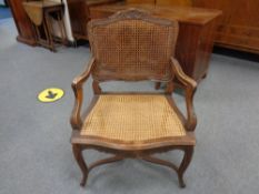 A carved beech French style salon armchair