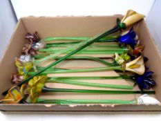 A box containing seventeen glass long stemmed flowers