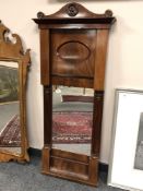 A 19th century mahogany mirror with pillared sides,