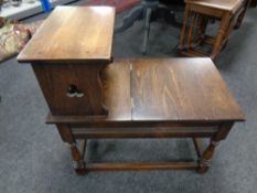 An oak storage telephone table together with an oak panel backed dining chair