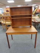 A 20th century Danish teak table, length 95 cm, together with a set of Danish teak bookshelves,