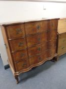 A 19th century oak serpentine fronted four drawer chest on cabriole legs,