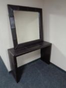 A contemporary brown leather console table with matching mirror