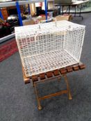 A folding metal luggage stand together with a wire metal cage